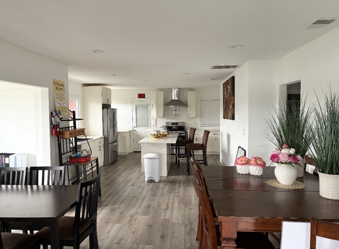 Open kitchen and dining area with island seating and stainless appliances