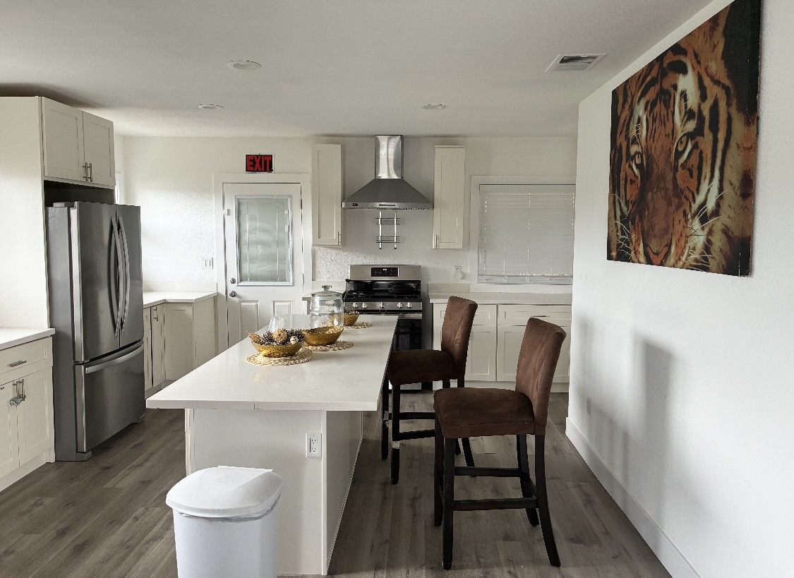 Modern kitchen with island seating and stainless appliances