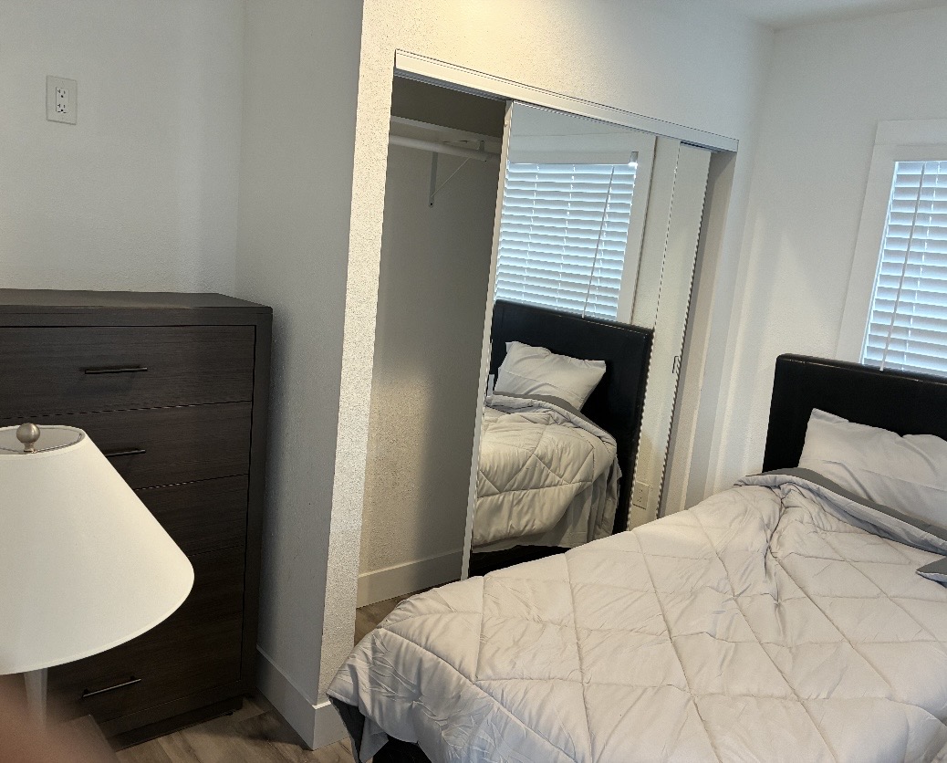 Bedroom with mirrored closet and ample natural light